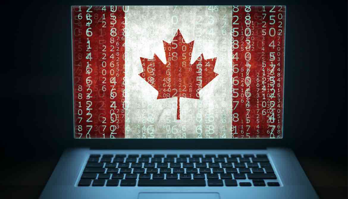  Laptop with binary computer code and Canada flag on the screen