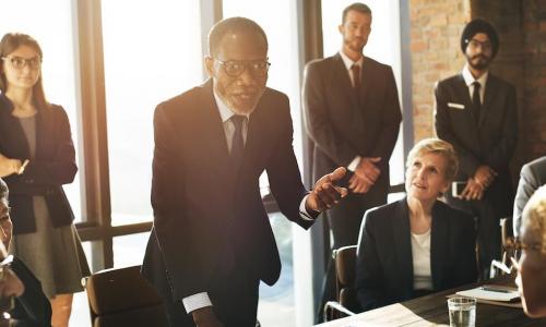 Business leader engaging confidently with his team