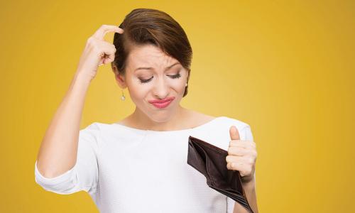 Woman scratches head while looking at empty leather wallet