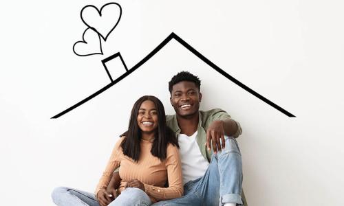 happy young Black couple sit under drawing of a house roof