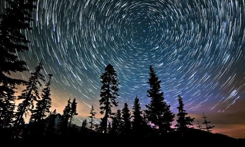 time lapse image of a starry night sky with the North Star in the center