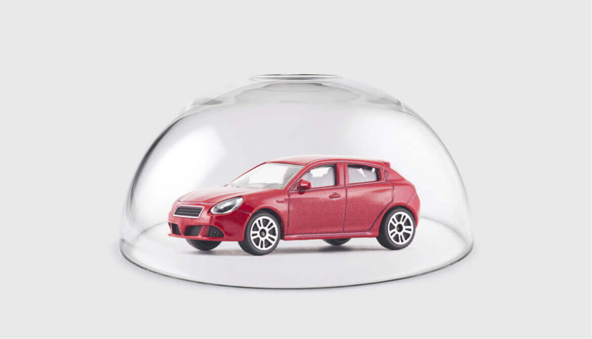 Red car protected under a glass dome