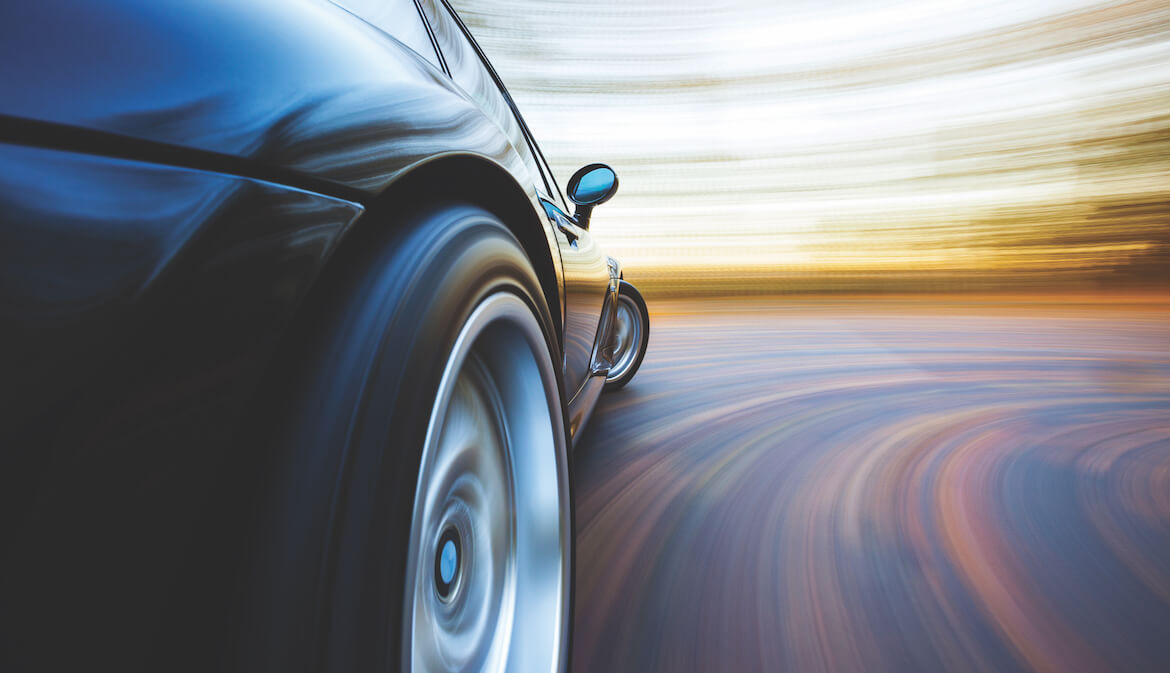 a car speeds down a road