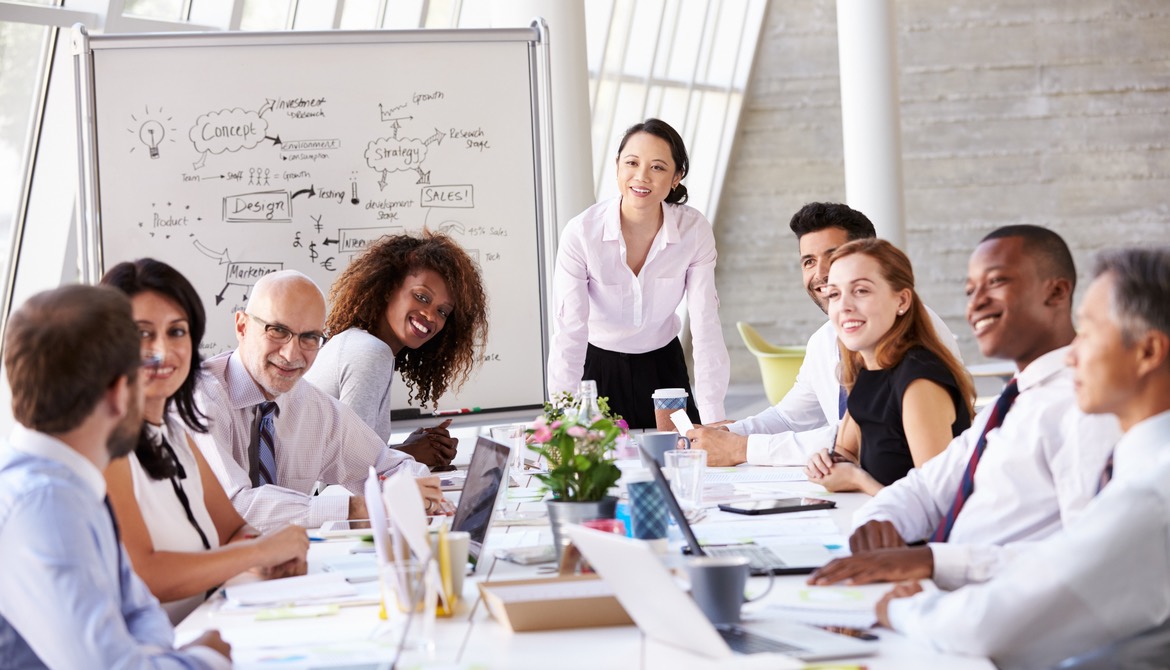 a diverse group of people at a board table