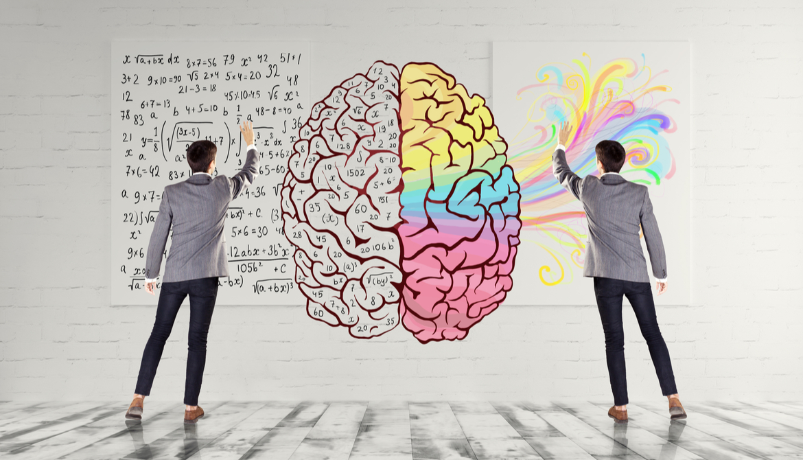 two business people draw and color in an illustration of a brain