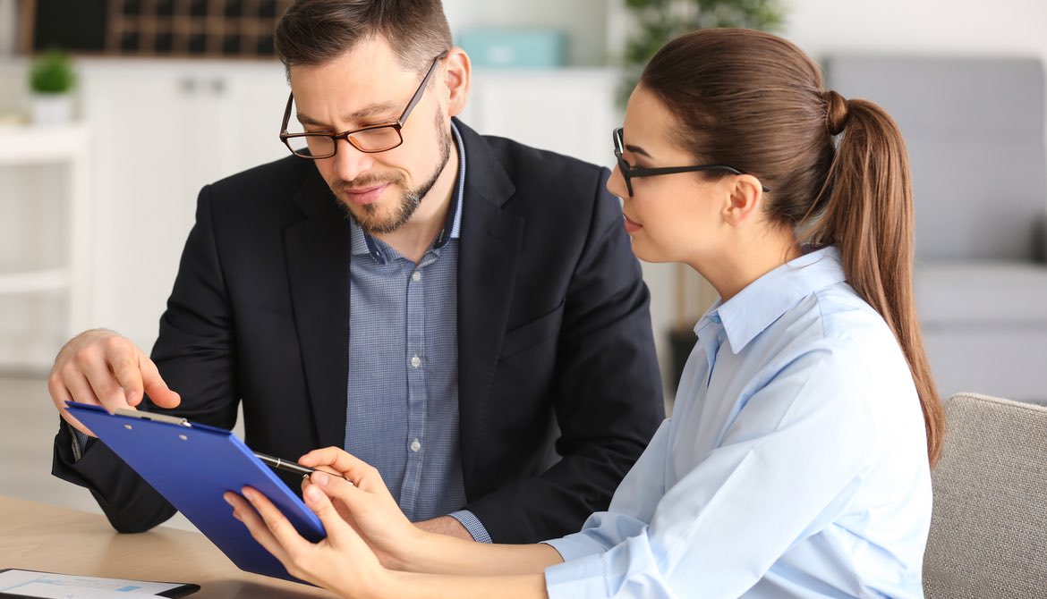 two executives work together on a tablet