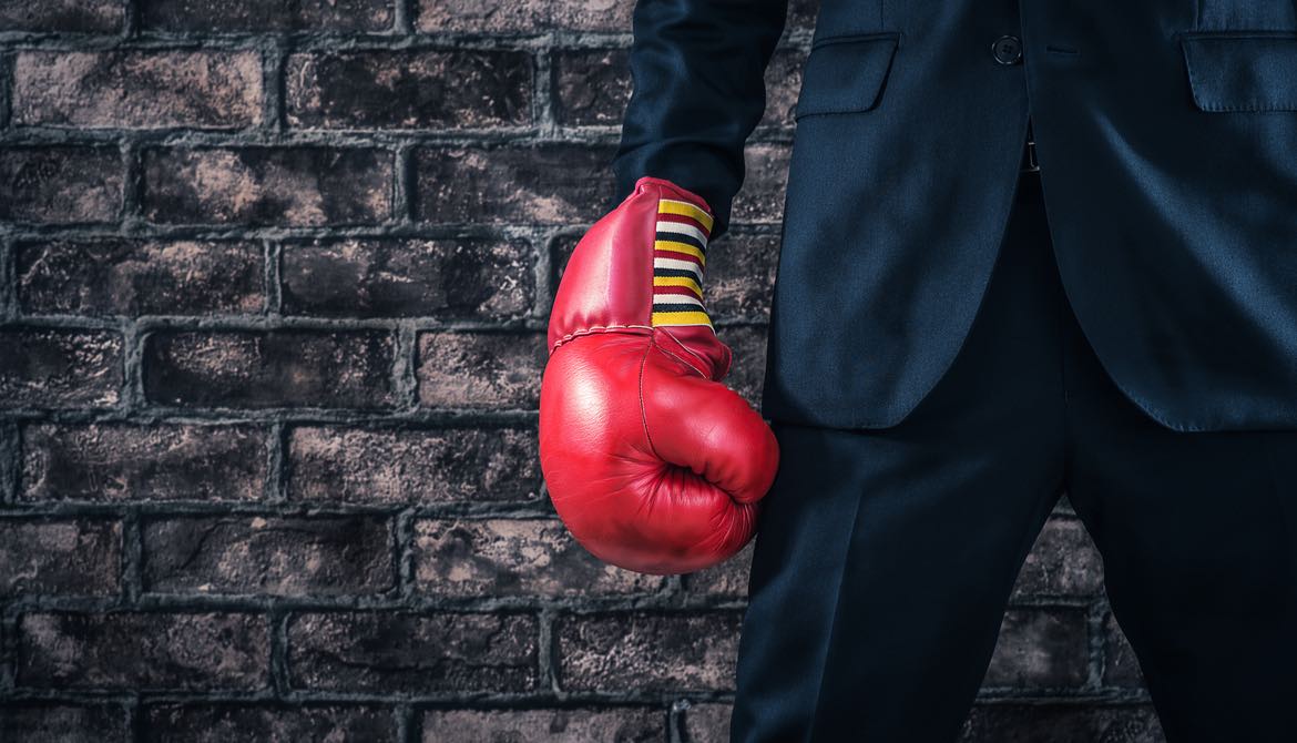 executive wearing red boxing glove