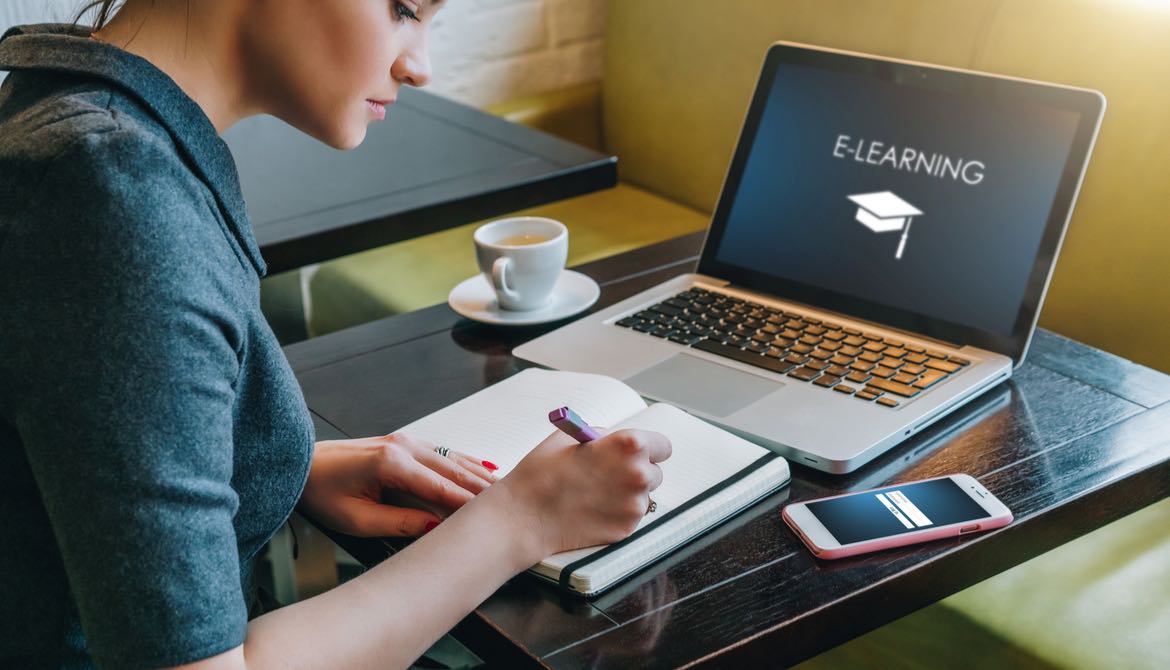 young woman with laptop and notebook