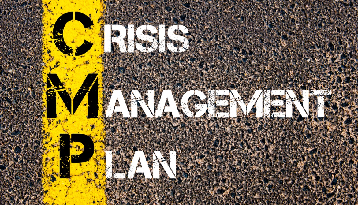 CRISIS MANAGEMENT PLAN painted on an asphalt road