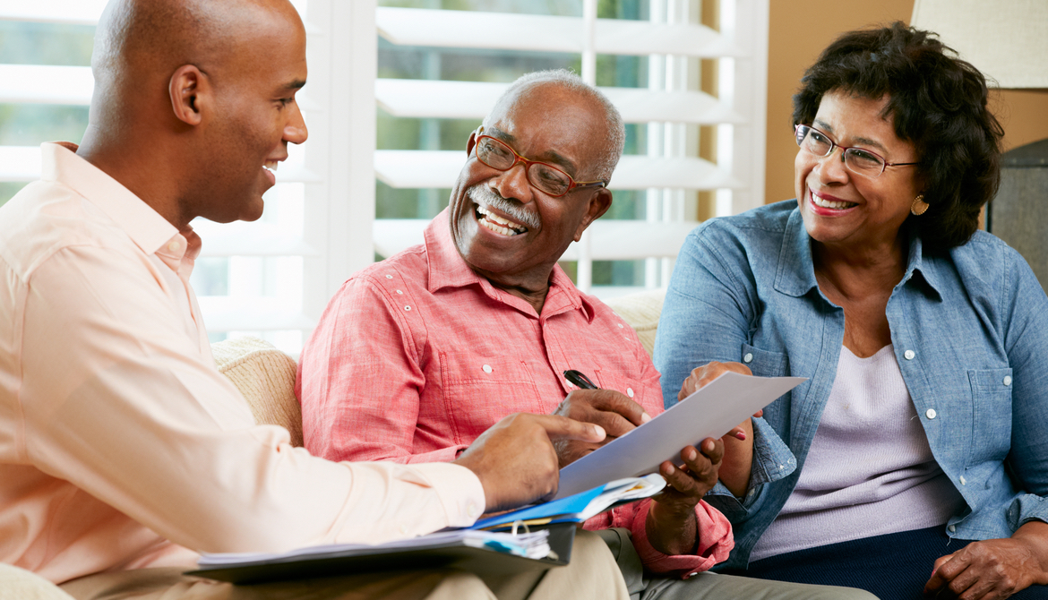 financial advisor talking to senior couple at home