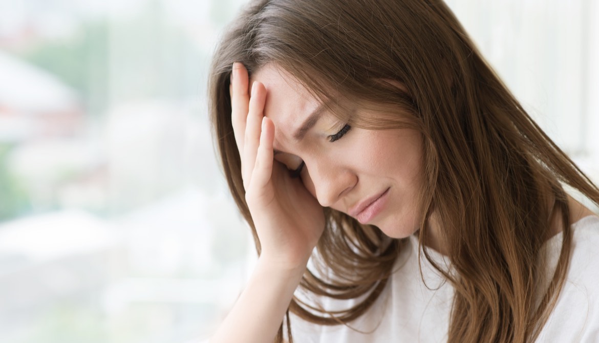 distressed woman holding her head