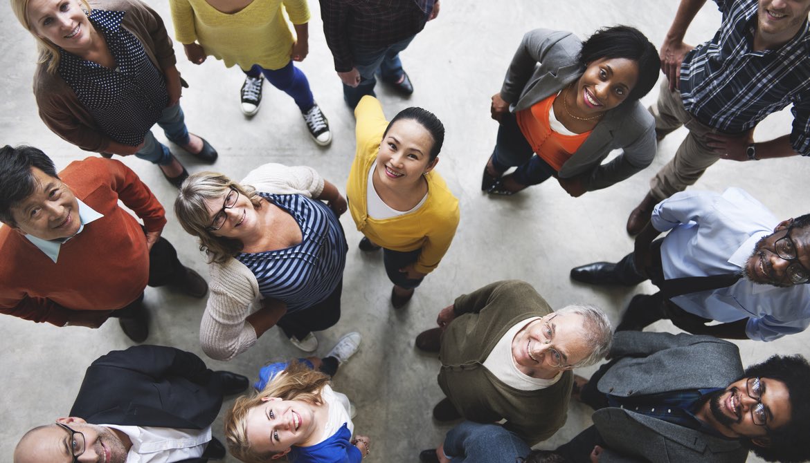 group of diverse people looking up and smiling