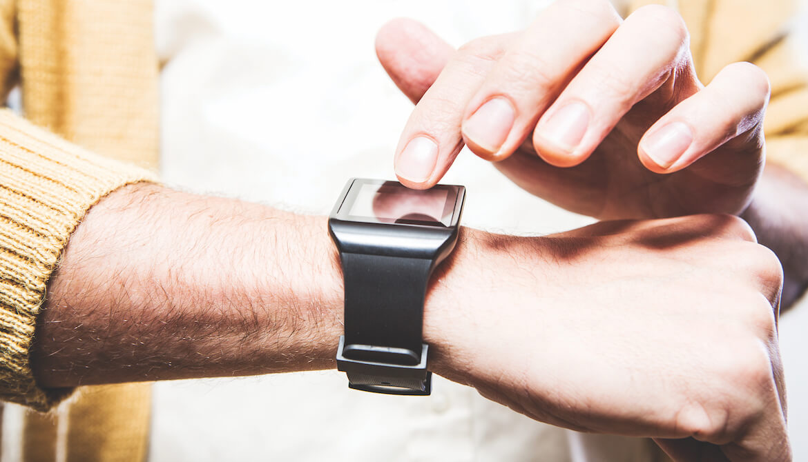 man checks his smartwatch