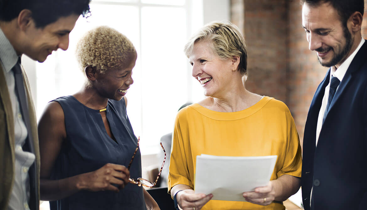 diverse group of male and female board members discuss report