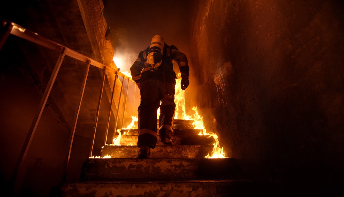 firefighter going into fire, up stairs