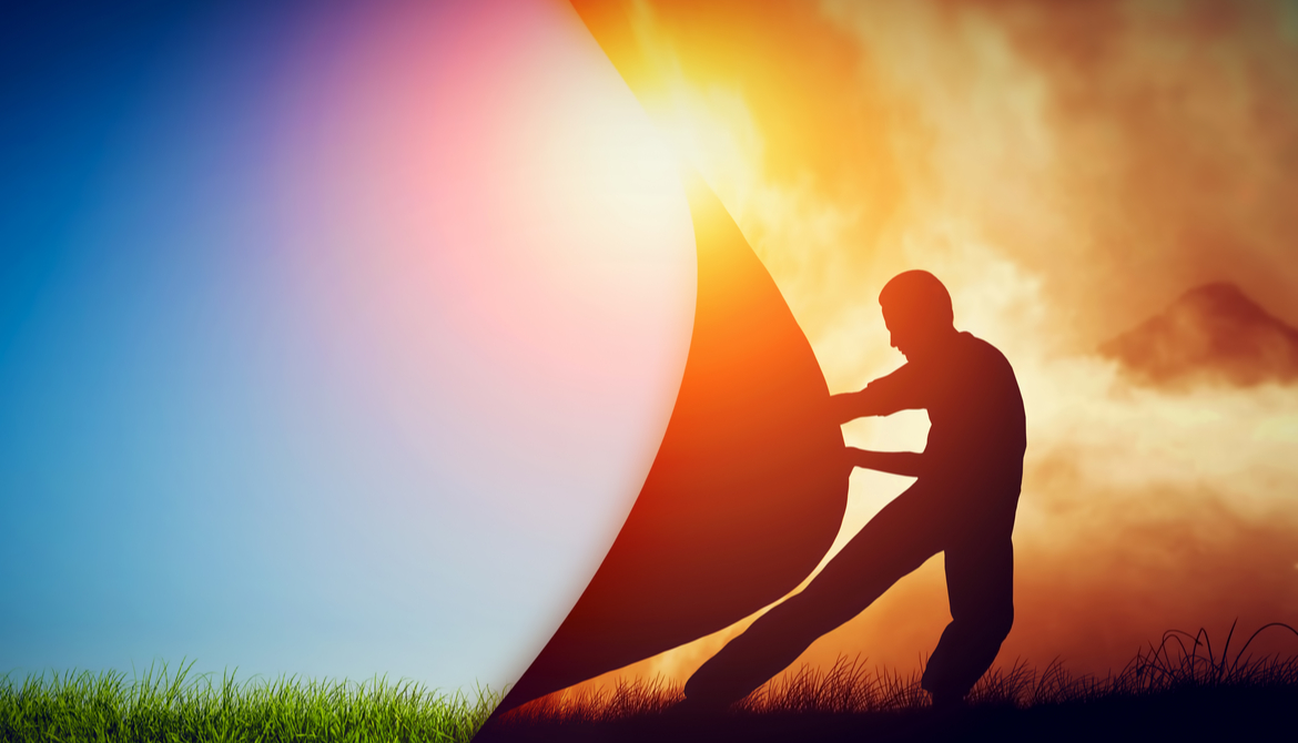 man pulling back curtain to reveal blue sky