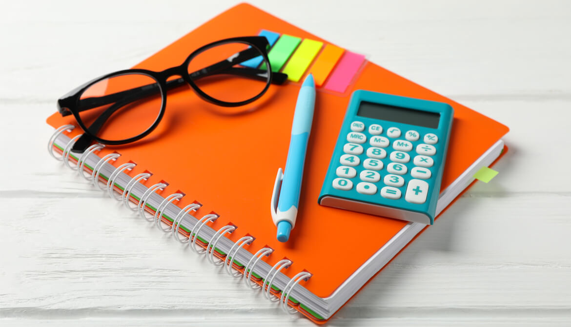 calculator with colorful office supplies