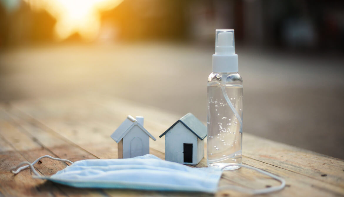 wooden houses with hand sanitizer and mask