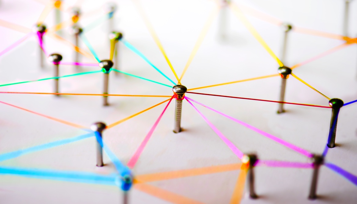 nails in a board connected by colorful string