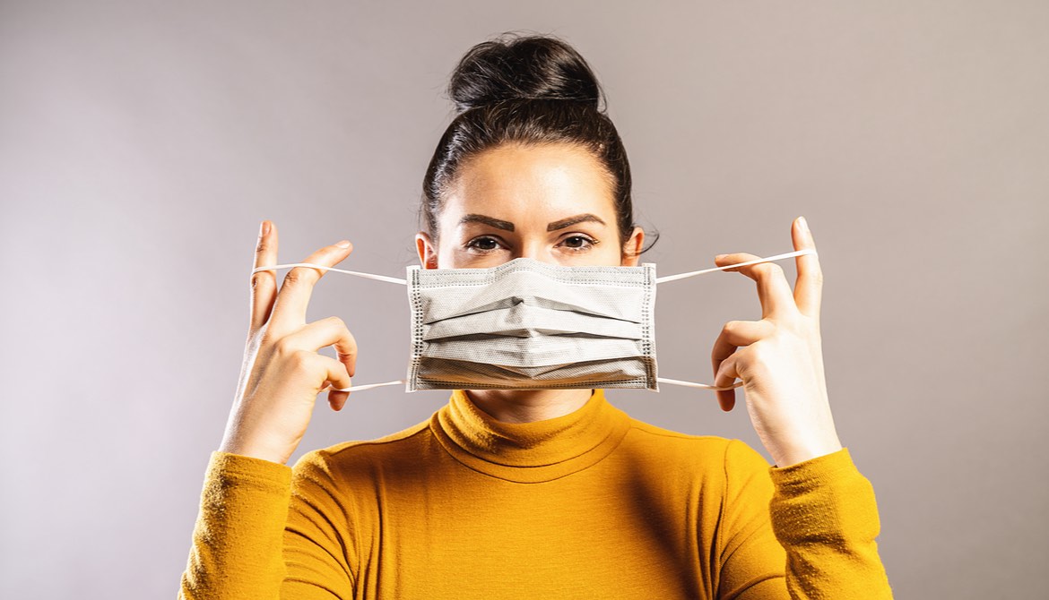 Woman puts on face mask