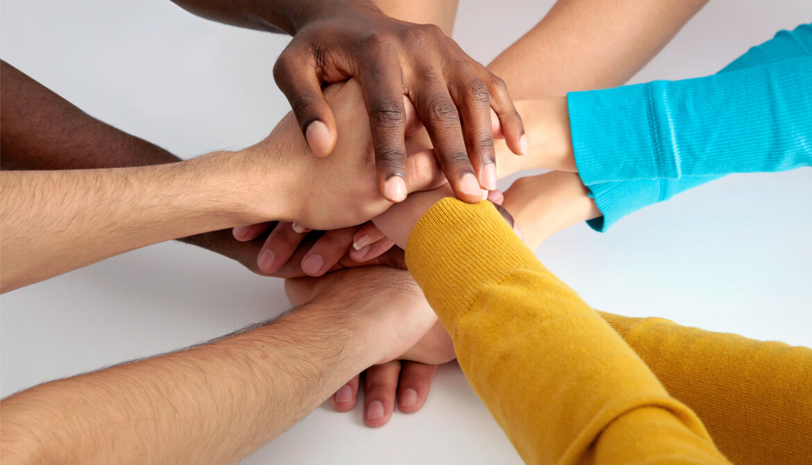 Business team putting their hands on top of one another