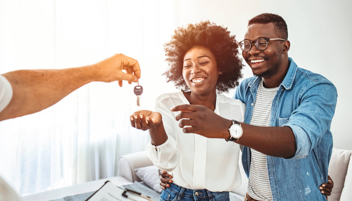 couple getting keys to home