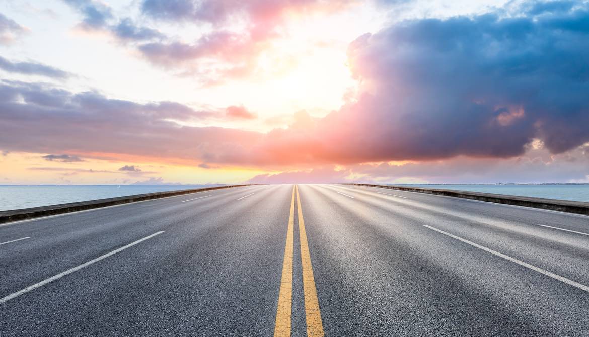 road leading to sunset on the horizon