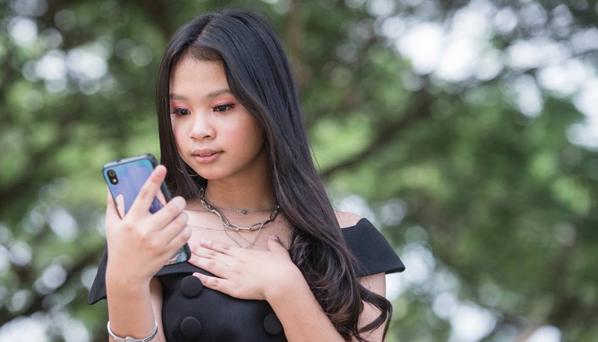 anxious Gen Z woman with smartphone