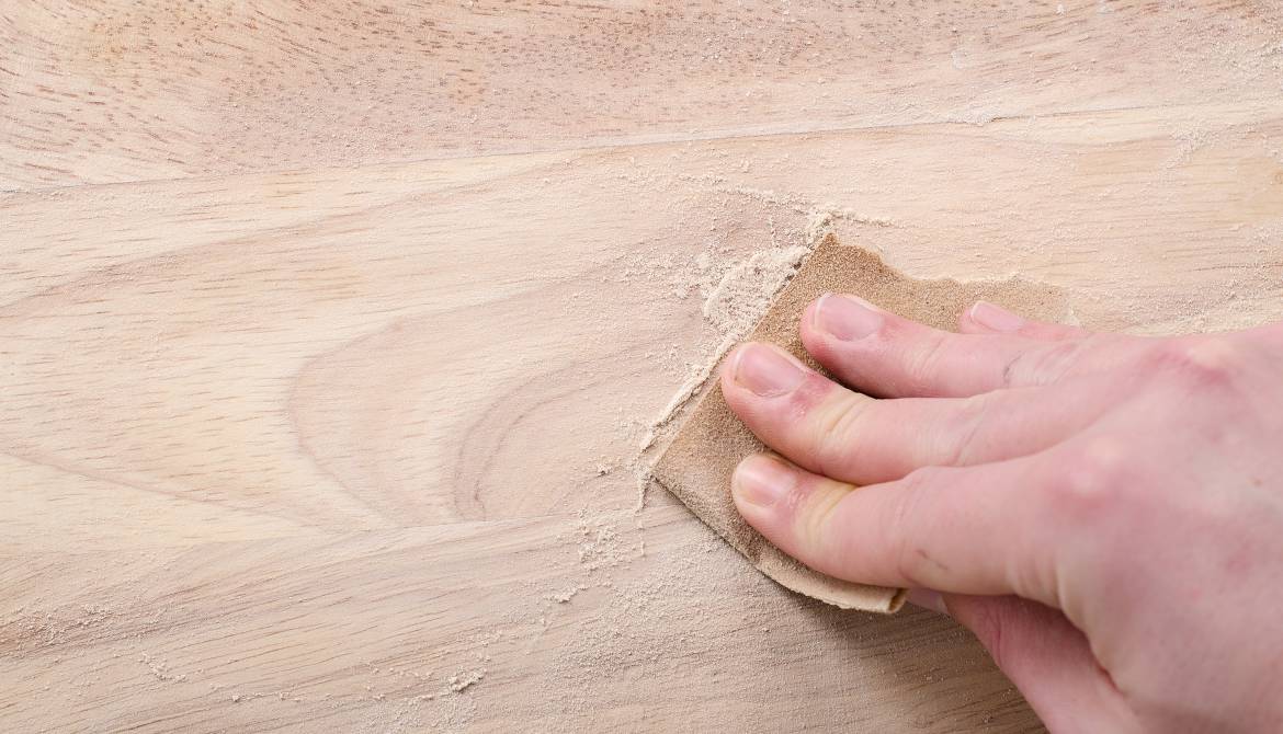 hand working with sand paper