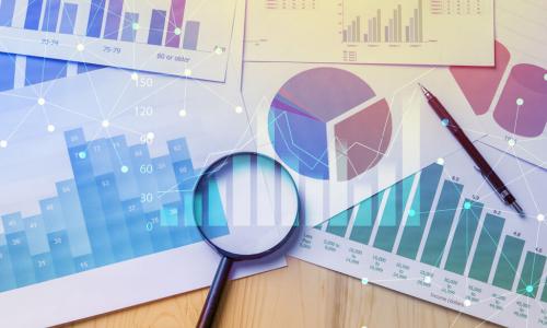 Magnifying glass with papers with data