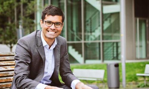 Smiling business man reading a tablet