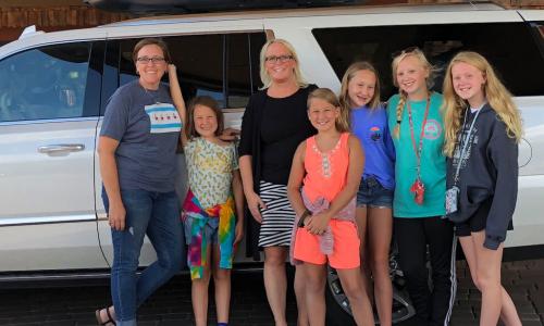 aughters demonstrating their buy-in in front of the car before leaving Sedona