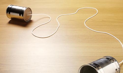 two tin cans joined by string showing communication