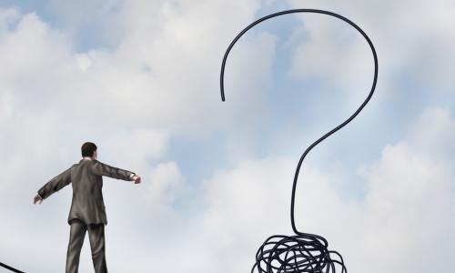 businessman walking tight rope toward a question mark in the air