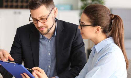 two executives work together on a tablet