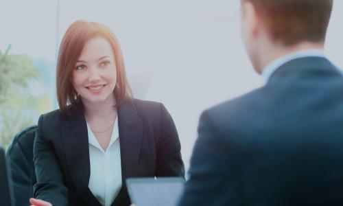 young female executive getting advice from a colleague