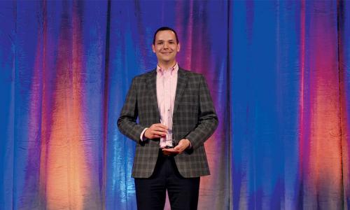 James Sackett on stage after accepting his award