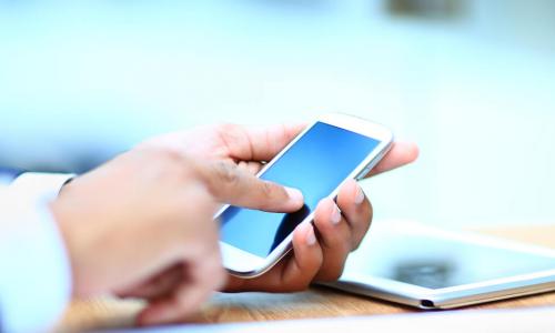 Young businessman working on mobile smartphone