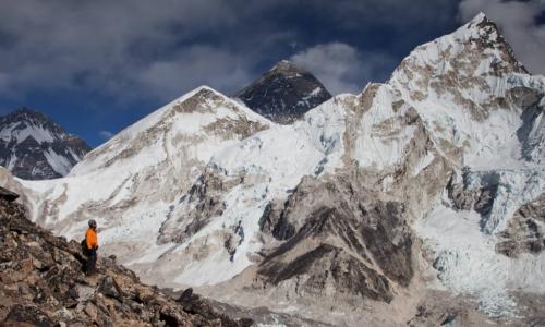 man looking up at Mt. Everest 