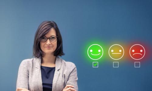 female executive with green smiley face chosen