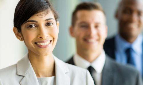 female executive from India with colleagues out of focus