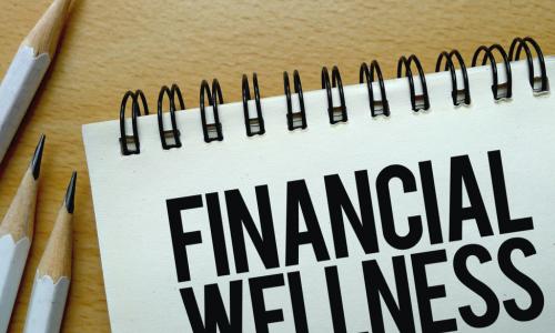 Financial Wellness text written on a notebook with pencils