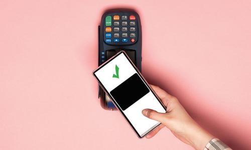 hand reaching out with smartphone to pay with digital wallet at contactless card reader