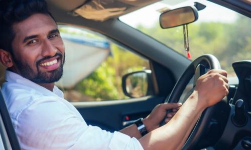 smiling man sitting in a car