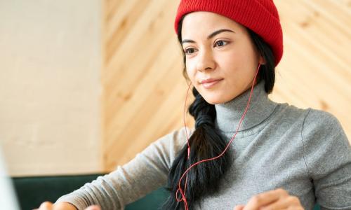 young woman red cap laptop