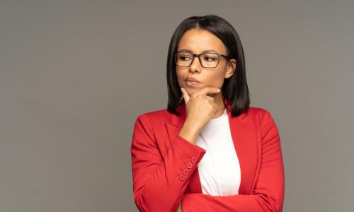 female executive in red sweater thinking