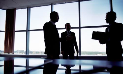 shady group of men in suits discussing business