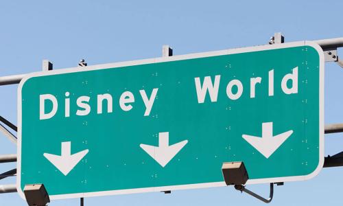 highway road sign pointing way to Disney world